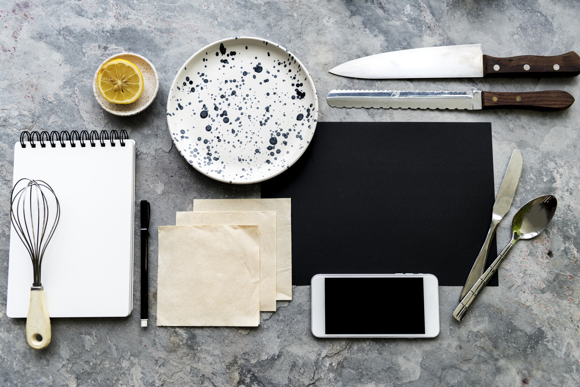 Assorted lesson materials: notepad, knives, small plates